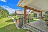 Covered patio featuring wood-finish flooring, exposed wooden support beams, and recessed ceiling lighting