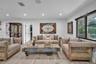 Interior space featuring wood-finish flooring, recessed lighting, and large windows with black frames