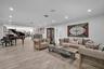 Open-concept interior featuring light-toned wood-finish flooring, recessed lighting, and integrated ceiling speakers