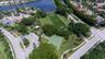 Recreational area featuring a soccer field, basketball court, paved parking, and landscaped grounds