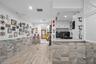 Utility area featuring wood-finish flooring, stone-tiled wall accents, recessed lighting, and white cabinetry with a quartz countertop