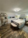 Wood-finish flooring, recessed ceiling lighting, and horizontal window shades