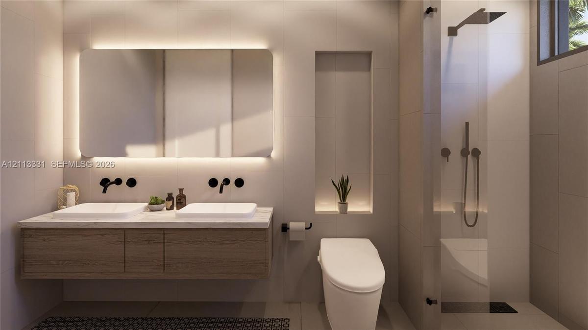 Floating dual-sink vanity with matte black wall-mounted faucets, large LED-backlit mirror, recessed wall niche, and glass-enclosed shower with matte b