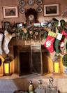 Fireplace featuring large-format tile surround, full-width hearth, and metal tri-fold screen