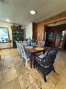 Tiled stone flooring, natural wood-paneled walls, and recessed ceiling lighting