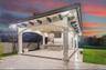 Covered patio featuring architectural columns, exposed corbel brackets, recessed lighting, and an outdoor kitchen with stone-veneer cladding and tile 