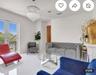 Large-format porcelain tile flooring, ornate crystal chandelier, and glass-paned double doors with black metal railing