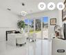 High-gloss tiled flooring, modern circular pendant lighting, and full-length glass paneled double doors with sidelights