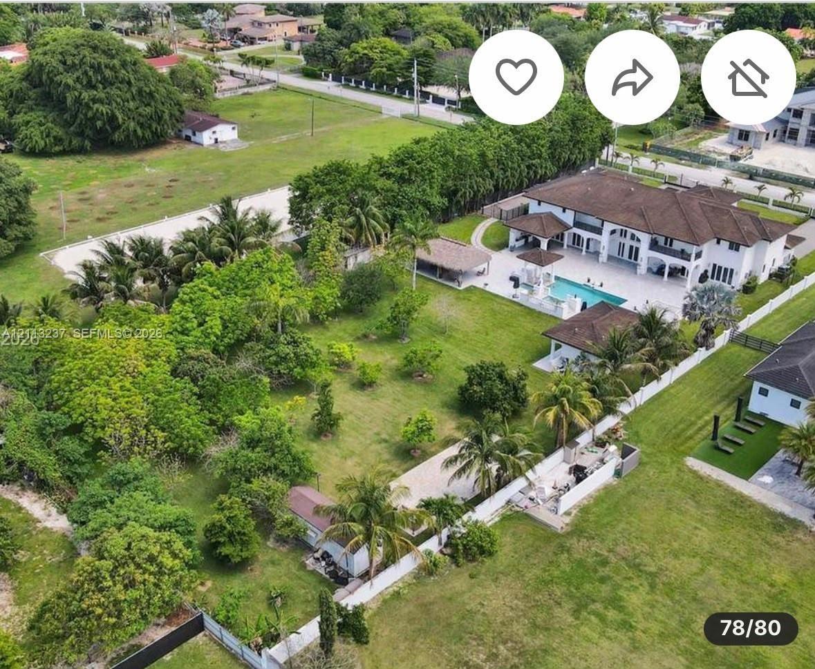 Expansive grounds featuring a multi-structure estate, a swimming pool, a detached covered patio, and mature landscaping
