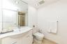 Bathroom featuring a white vanity with an integrated basin, a polished chrome faucet, a full-wall mirror, recessed lighting, and tile flooring