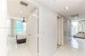 Glossy tile flooring, recessed ceiling lighting, and multiple interior passage doors