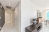 Interior hallway featuring polished tile flooring, recessed ceiling lighting, and contrasting dark-toned accent wall