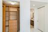 Custom built-in wood-finish shelving and drawer storage with overhead flush-mount lighting