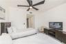 Four-blade matte black ceiling fan with integrated lighting and smooth white wall finish