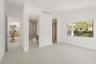 Interior room featuring wood-finish flooring, recessed lighting, expansive picture window, and built-in closet cabinetry