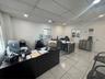 Interior room featuring recessed ceiling lighting, grid-pattern ceiling tiles, and large-format ceramic floor tile