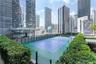 Tennis court featuring a high-performance surface, perimeter fencing, professional net, integrated basketball hoop, and manicured hedge borders