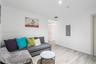 Neutral interior space featuring wood-finish flooring, smooth white wall finishes, and light-toned interior doors