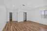 Room featuring wood-finish flooring, recessed lighting, white horizontal-panel doors, and built-in shelving within the closet space