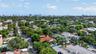 Aerial perspective of a residential property featuring a clay tile roof and dense mature tree canopy