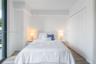 Wood-finish flooring, full-height sliding glass door, and built-in closet with white panel doors