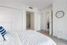 Neutral interior featuring wood-finish flooring, floor-to-ceiling bi-fold closet doors, and wood-grain interior doors