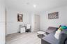 Neutral-toned interior space featuring wood-finish flooring and solid-core interior doors with matte-finish hardware