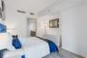 Neutral wall paint, wood-finish flooring, and minimalist architectural trim