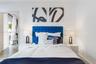 Room featuring white interior wall paint and wood-finish flooring