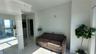 Interior space featuring polished stone-finish flooring, floor-to-ceiling glass paneling, and mirrored closet doors