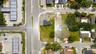 Corner lot featuring street frontage, cleared land, and mature perimeter trees