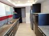 Kitchen featuring dark cabinetry, stone countertops, stainless steel appliances, recessed ceiling lighting, and wood-finish tile flooring