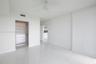 Interior space featuring white stone-finish tile flooring, ceiling fan with integrated lighting, and walk-in closet with built-in shelving and drawer 