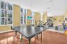 Fitness center featuring floor-to-ceiling windows, wood-finish flooring, and recessed ceiling lighting
