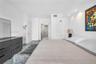 Neutral-toned interior featuring recessed ceiling lighting, glossy light-colored flooring, and smooth-finish walls