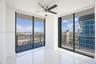 Third bedroom, floor-to-ceiling windows, polished stone-finish flooring, integrated balcony access, and a multi-blade ceiling fan with light fixture