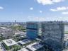 Aerial perspective of high-rise structures featuring glass-paneled facades and architectural symmetry