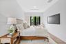 Wood-finish flooring, recessed lighting, and full-height glass-paned doors leading to exterior grounds