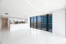 Open-concept living space featuring high-gloss tile flooring, floor-to-ceiling glass windows, and a minimalist kitchen equipped with white cabinetry a