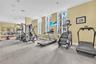 Fitness center featuring wall-to-wall mirrors, floor-to-ceiling windows, and recessed lighting