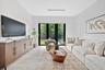 Neutral-toned interior featuring large-format tile flooring, recessed ceiling lighting, and black-framed French doors