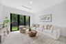 Neutral-toned large-format tile flooring, recessed ceiling lighting, and black-framed glass paneled doors featuring lever hardware
