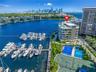 Waterfront property featuring a private marina, rooftop pool, and multi-sport court facilities