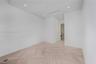 Neutral interior space featuring basket-weave pattern stone flooring, recessed ceiling lighting, and smooth-finish white walls