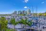 Deep-water marina featuring fixed and floating concrete docks, integrated boat slips, professional pylons, and tropical landscaping