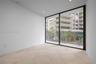 Floor-to-ceiling sliding glass door, recessed lighting, and light-toned wood-finish flooring arranged in a parquet pattern