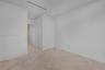 Minimalist interior featuring wood-finish parquet flooring, recessed ceiling lighting, and linear recessed ceiling detailing