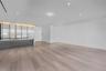 Interior space featuring wood-finish flooring, recessed ceiling lighting, and a kitchen island with stone countertop