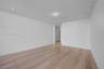 Minimalist interior featuring smooth walls, recessed ceiling lighting, and stone-finish flooring