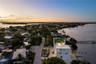 Waterfront property featuring a rooftop deck, private dock, multi-level exterior, and coastal location